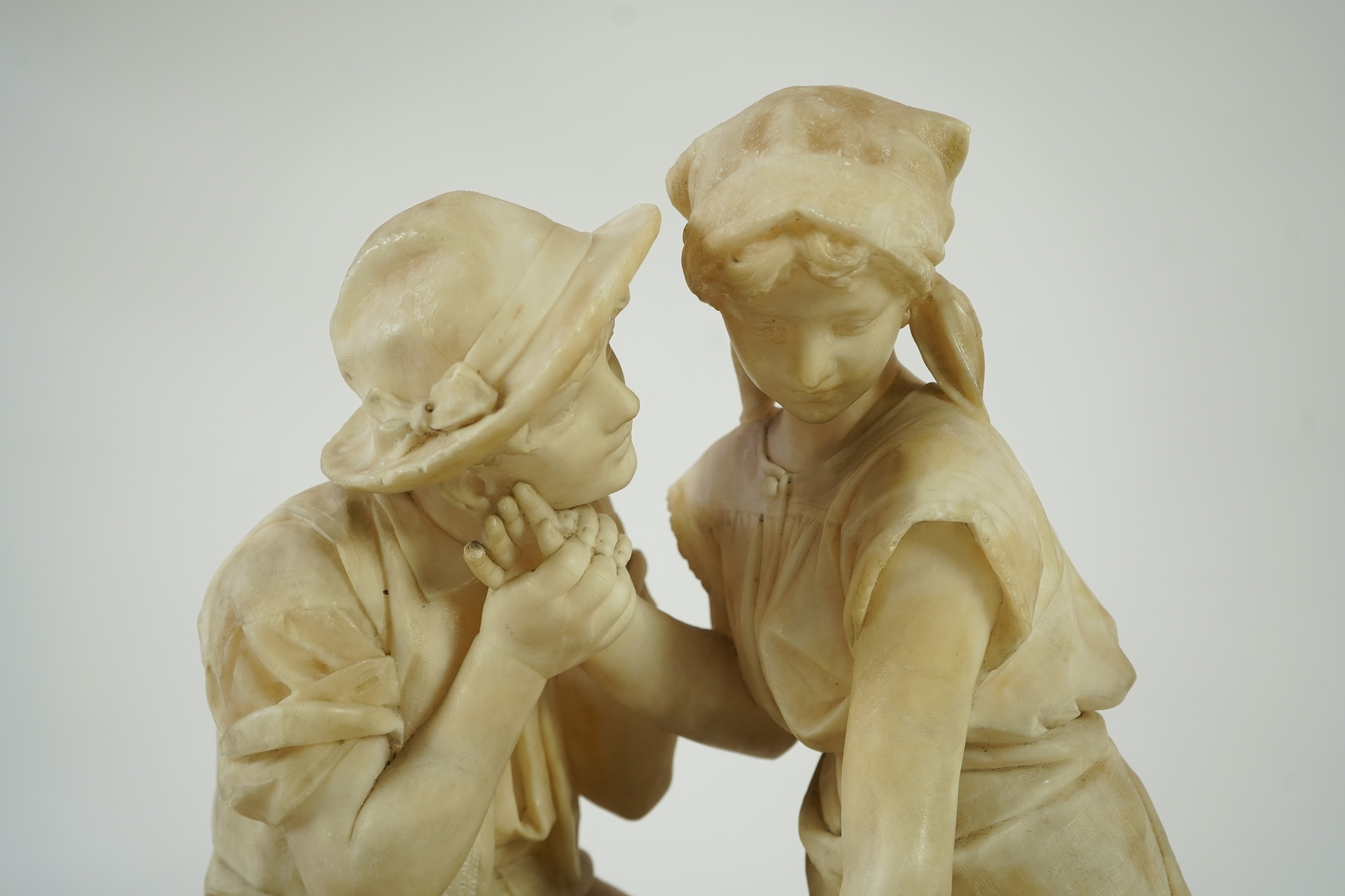 A large Continental alabaster group of a peasant couple, late 19th / early 20th century